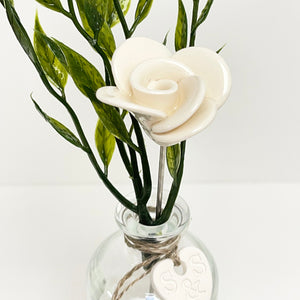 White ceramic rose in a bottle