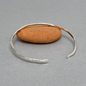 Open silver bangle - gold dot