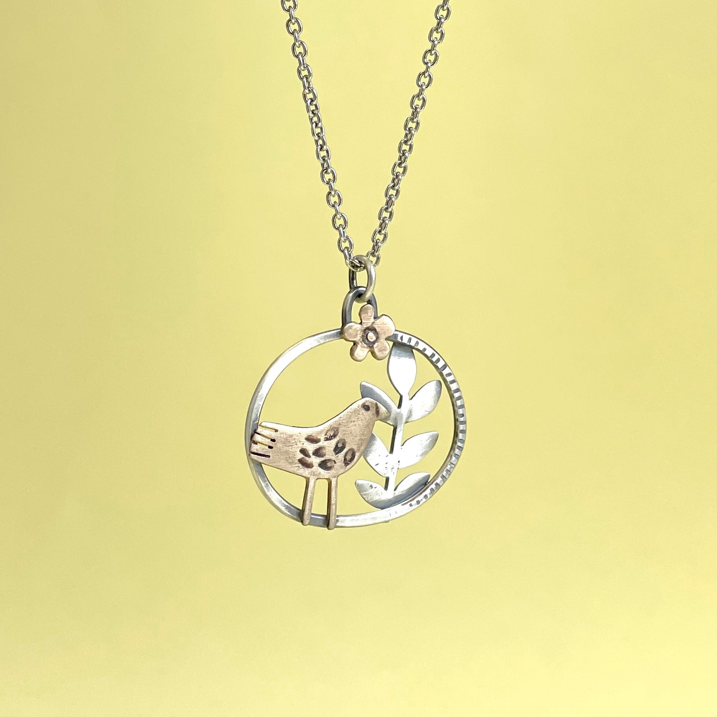 Brass bird, silver leaf pendant