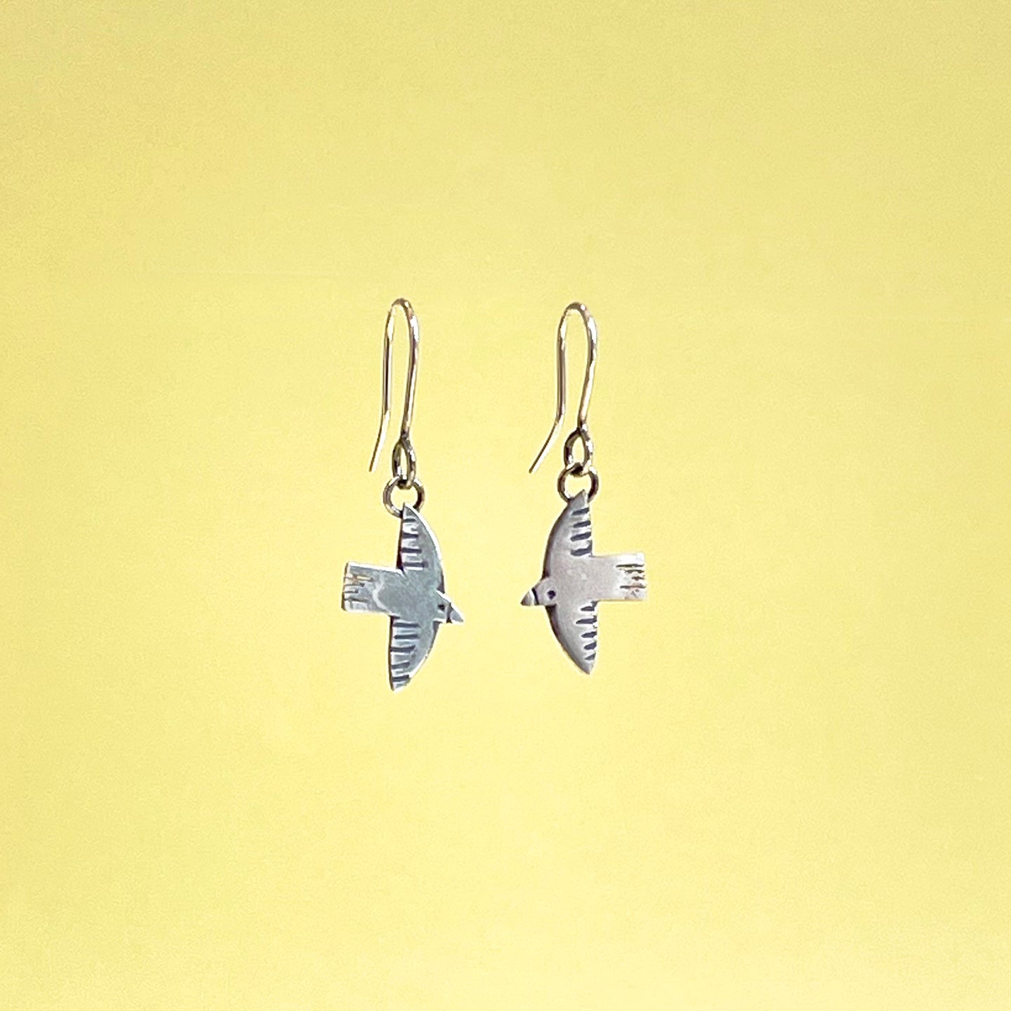 Silver flying bird drop earrings