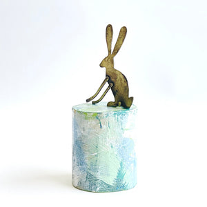 Little hare on plinth
