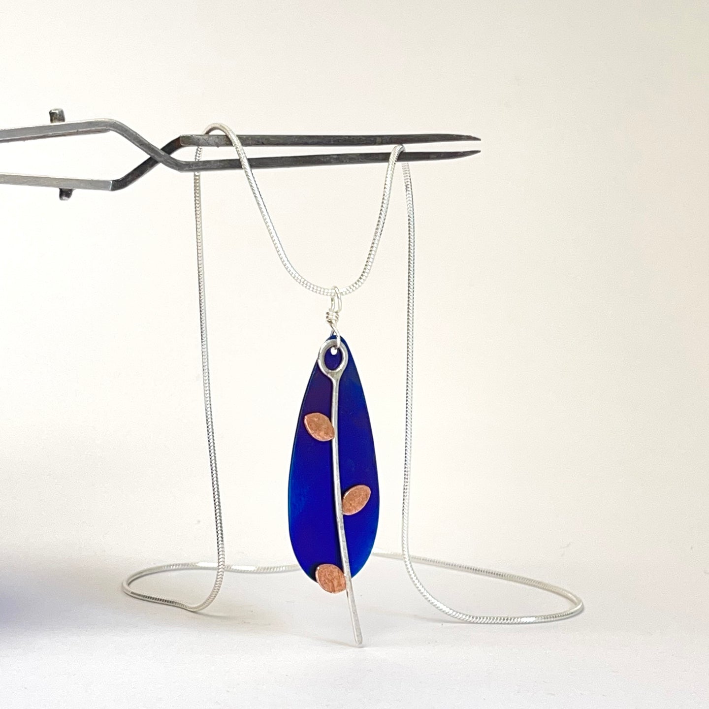 Silver, copper and titanium pendant a