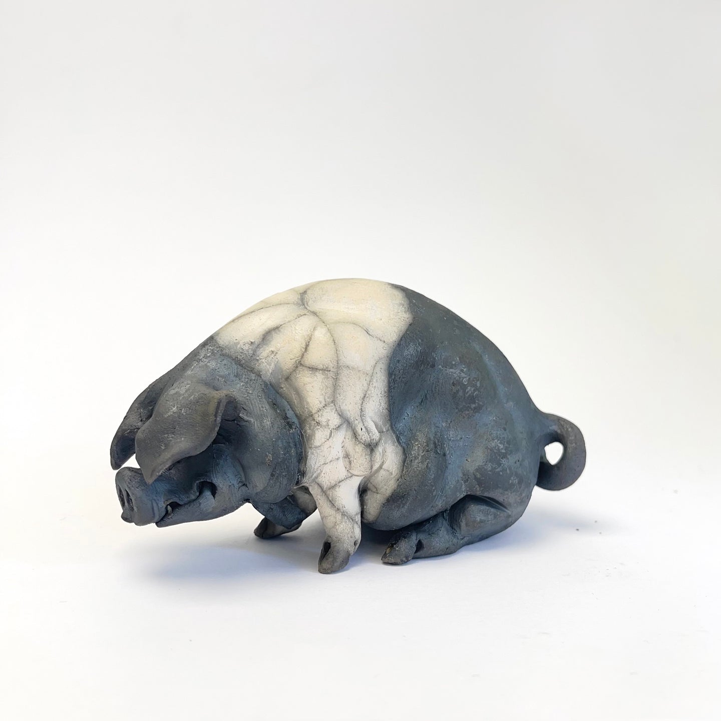Small sitting saddleback ceramic pig - Raku