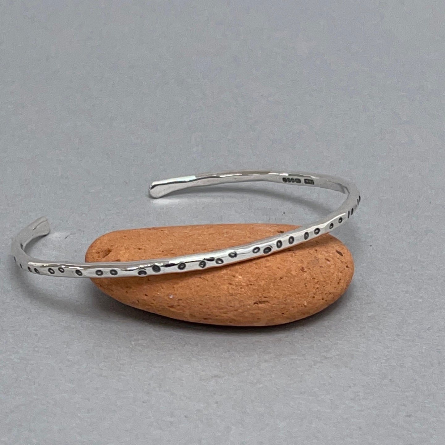 Open silver bangle - oval dots