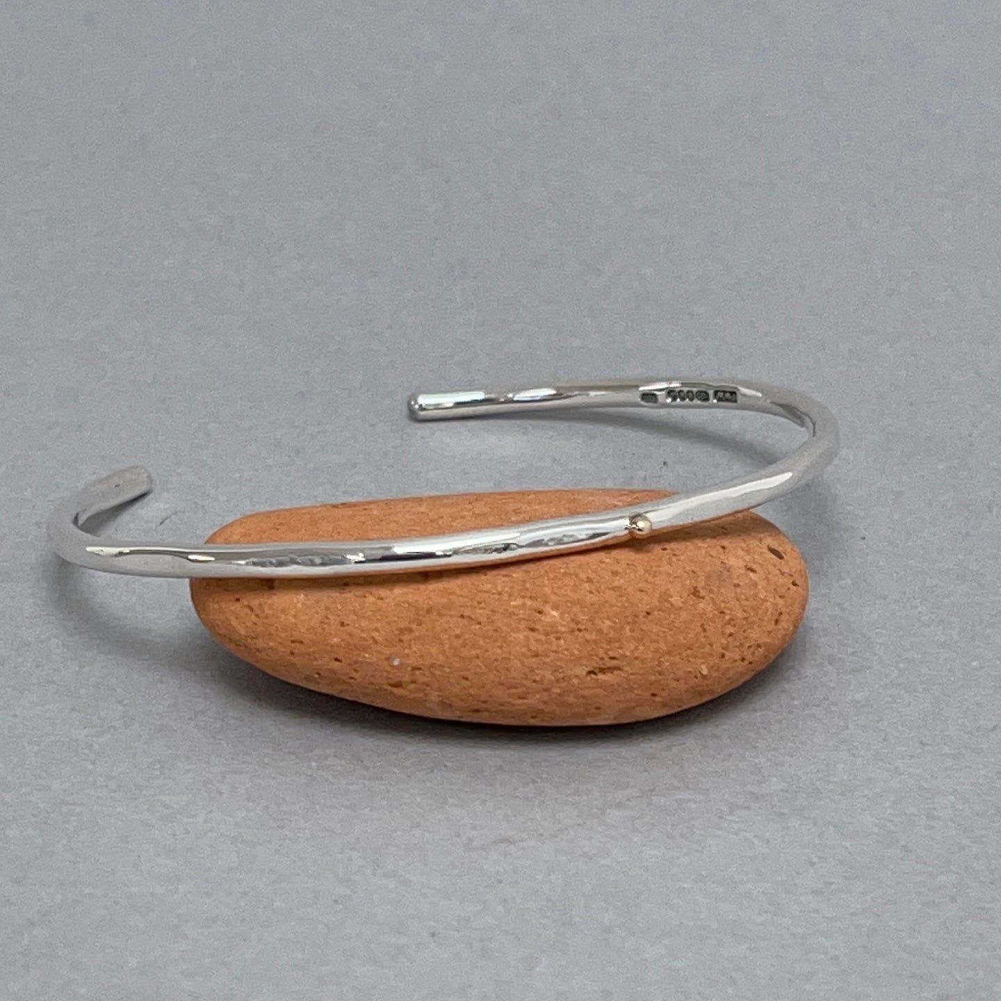 Open silver bangle - gold dot